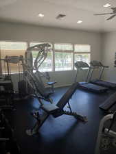 Workout area with ceiling fan and baseboards