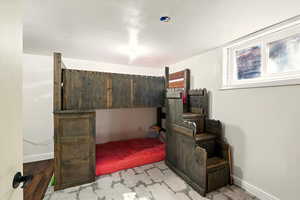 Bedroom featuring baseboards and wood finished floors
