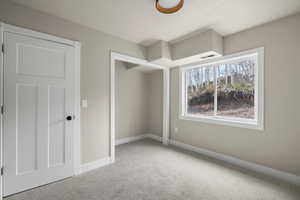Unfurnished bedroom featuring carpet floors and baseboards