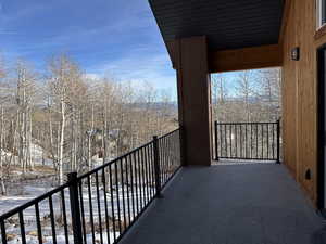 View of snow covered back of property