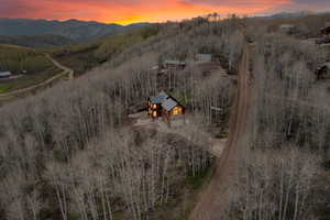 Aerial view of property and surrounding area featuring mountains