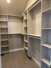 Spacious closet with light carpet