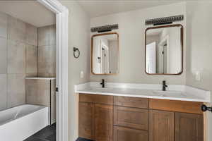 Bathroom with double vanity and tile patterned flooring