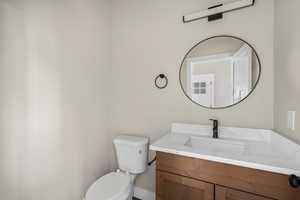 Half bathroom featuring toilet and vanity