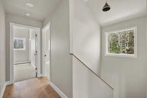 Hall featuring light wood-type flooring and baseboards