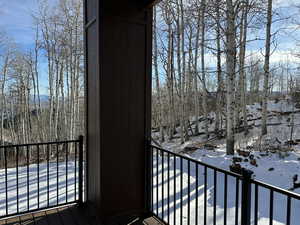 View of snow covered back of property
