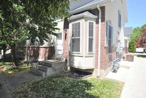 View of property exterior with brick siding