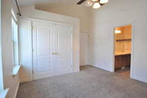 Unfurnished bedroom featuring carpet, a closet, and baseboards