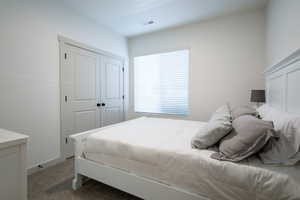 Bedroom featuring carpet and a closet