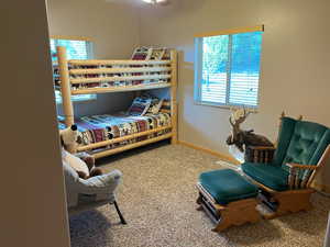 Carpeted bedroom featuring baseboards