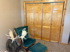 Living area with carpet floors and baseboards