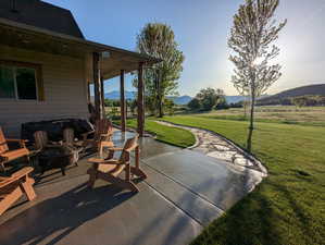View of patio with an outdoor fire pit and a mountain view