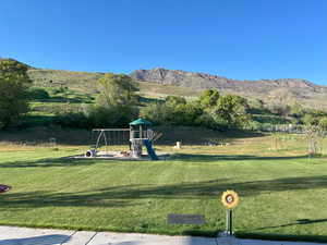 View of green lawn featuring a mountain view