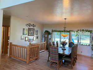 Dining area featuring wood finished floors and a textured ceiling