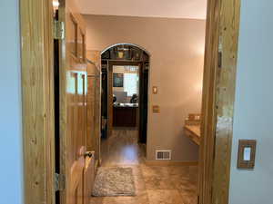 Corridor featuring arched walkways