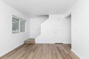 Unfurnished room featuring light wood-style floors and baseboards