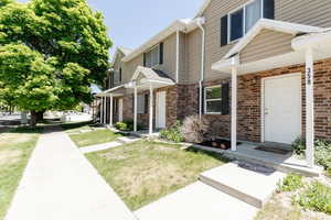 View of front of home featuring brick siding and a front lawn