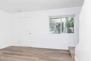 Empty room with light wood-style floors and baseboards