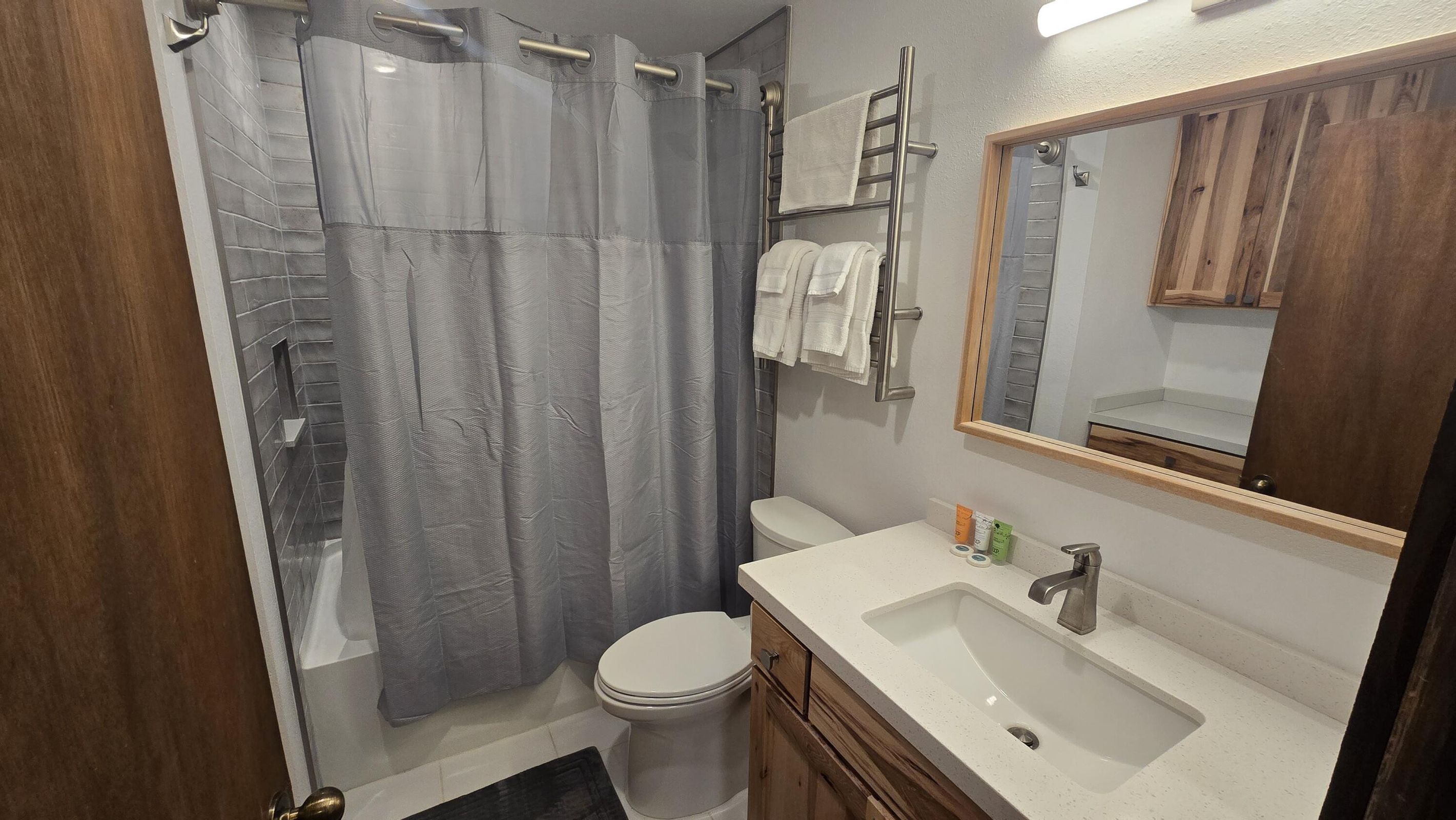 Full bathroom featuring toilet, vanity, and shower / bath combo with shower curtain