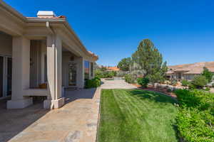 View of green lawn featuring a patio area and an outdoor pool