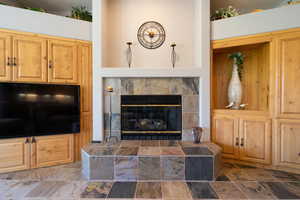 Living room featuring a fireplace and stone finish floors
