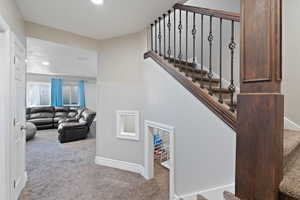 Staircase with carpet flooring, baseboards, and recessed lighting