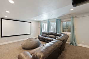 Cinema room featuring recessed lighting, carpet flooring, baseboards, and a textured ceiling