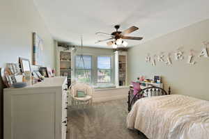 Bedroom with carpet flooring, ceiling fan, and baseboards