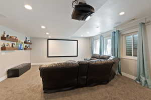 Cinema room with carpet floors, recessed lighting, and baseboards