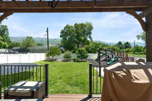 View of yard featuring a mountain view and a playground