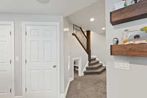 Stairway with carpet flooring, baseboards, and recessed lighting
