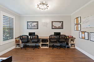 Office area with ornamental molding, a chandelier, wood finished floors, and baseboards