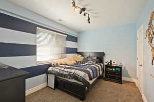 Carpeted bedroom with baseboards