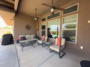 View of patio with outdoor lounge area and ceiling fan