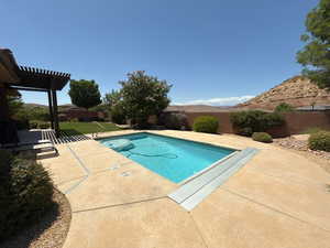 View of swimming pool with a patio and a pergola