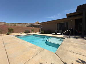 View of swimming pool with a patio and a fenced backyard