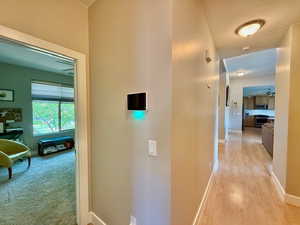 Hall with baseboards and light wood finished floors