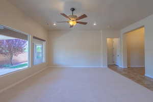 Spare room with recessed lighting, ceiling fan, baseboards, and light carpet