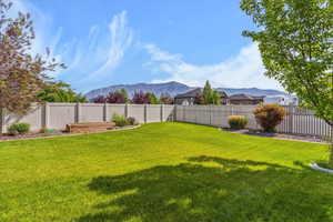 View of fully fenced back yard, garden boxes and  an unobstructed mountain view.