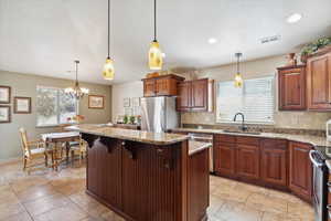 Kitchen, granite countertops, stainless steel appliances and a kitchen island.