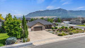 View of front of house featuring a mountain view, a residential view, a garage, and concrete driveway