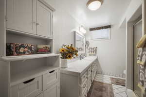 Bathroom with vanity, a shower stall, tile patterned flooring, and toilet