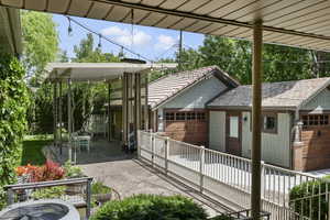 View of patio featuring cooling unit and a garage