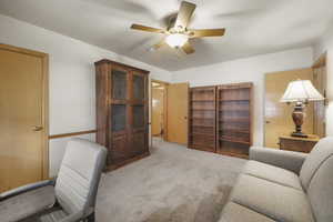 Office with ceiling fan and carpet floors