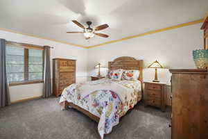 Bedroom featuring carpet floors, ceiling fan, and baseboards