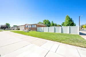 View of side of home with brick siding, a garage, and concrete driveway