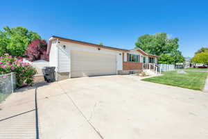 Single story home featuring driveway and a garage