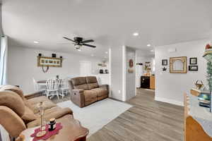 Living area featuring ceiling fan, light wood-type flooring, recessed lighting, and baseboards
