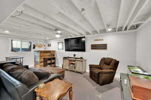 Living area featuring finished concrete floors and baseboards
