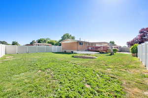 View of yard with a wooden deck